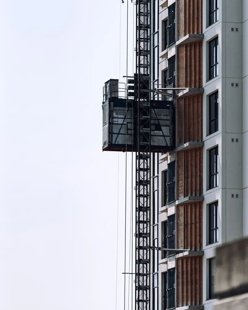 Construction hoist running up the facade of a building under construction