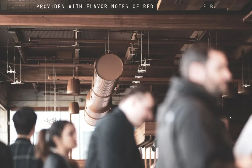 Customers waiting inside a busy restaurant