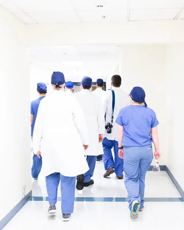 Doctors and nurses walking down a hospital corridor