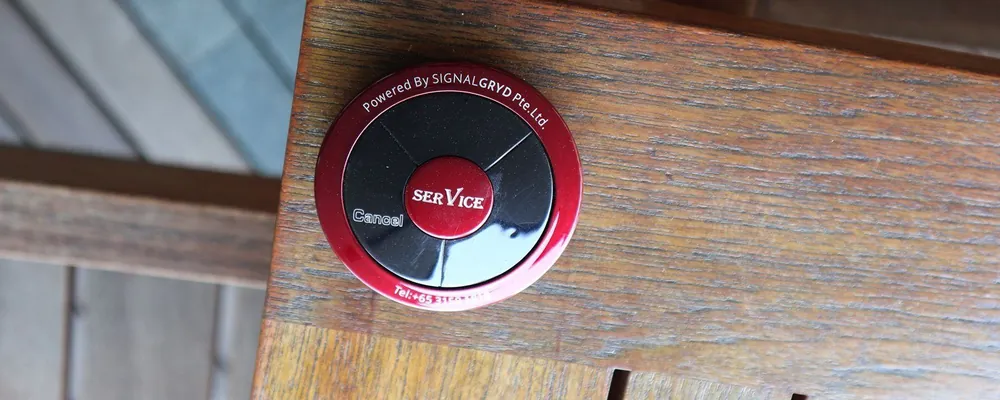 Red Series Modern call button on a wooden table
