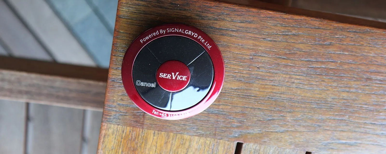 Red Series Modern call button on a wooden table