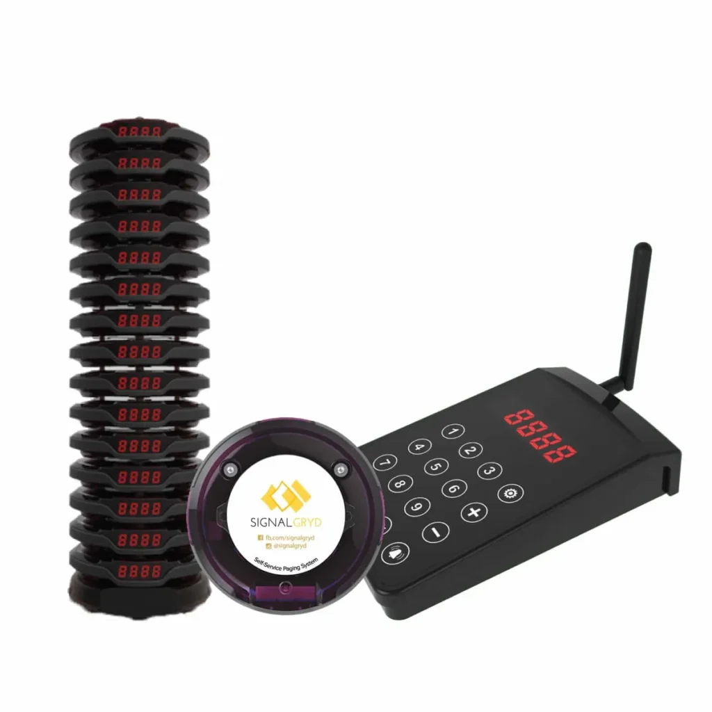 Series Pacific pagers stacked on the charging base beside the keypad transmitter
