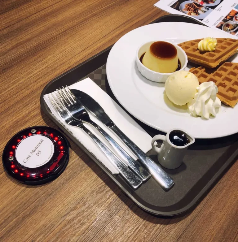 Series Pacific pager on a food tray beside waffles and ice cream