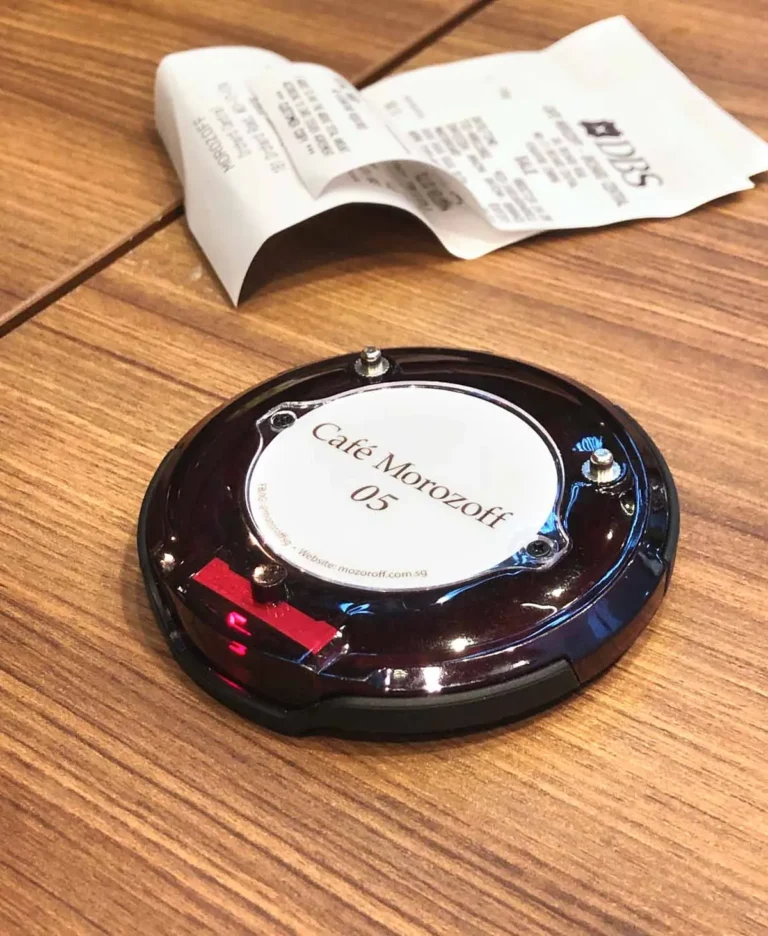 Series Pacific pager on a cafe table beside an order receipt