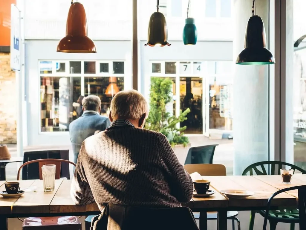 Customers seated in a cafe, waiting for their orders