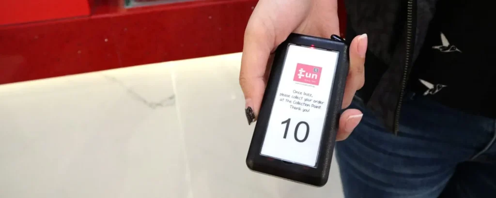 Hand holding a Series Slim pager showing number 10