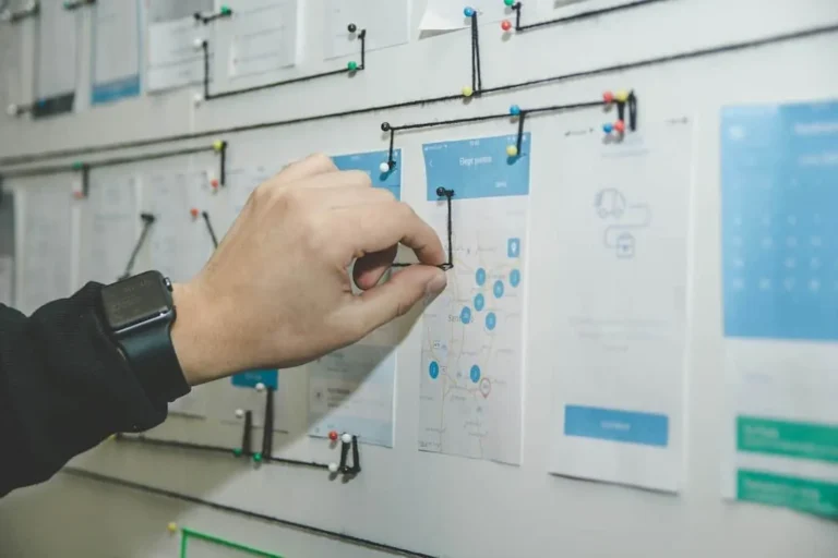 Hand pointing at a customer-flow chart on a whiteboard