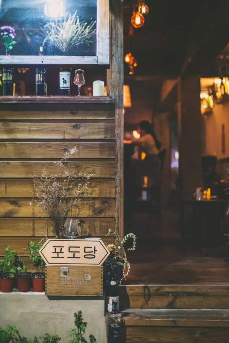 Restaurant entrance at night with a lit menu board