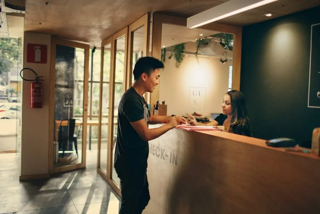 Guest talking to staff at a hotel reception desk