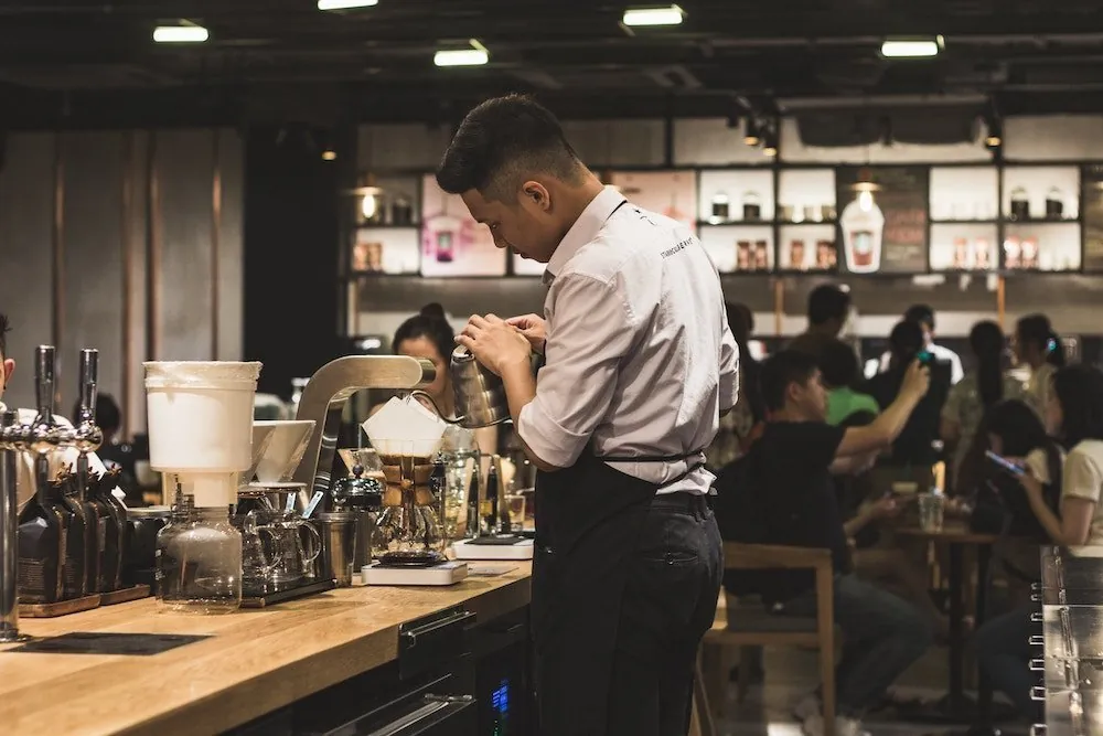 Barista preparing drinks in a busy cafe