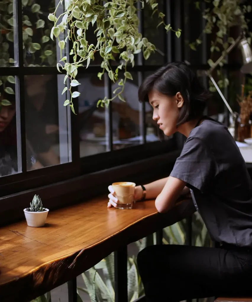 Customer waiting at a cafe window seat