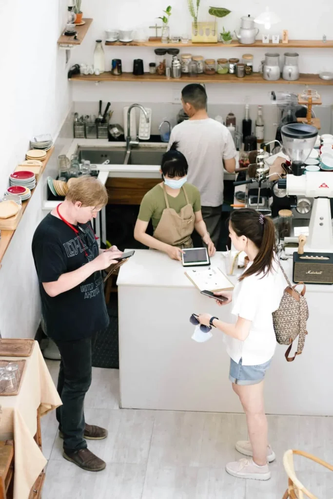 Customers and staff at a cafe counter