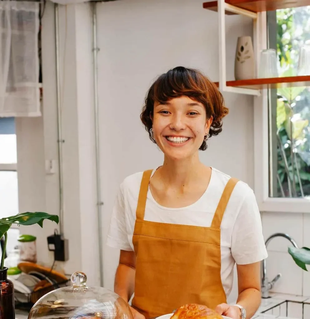 Smiling cafe staff member in an apron
