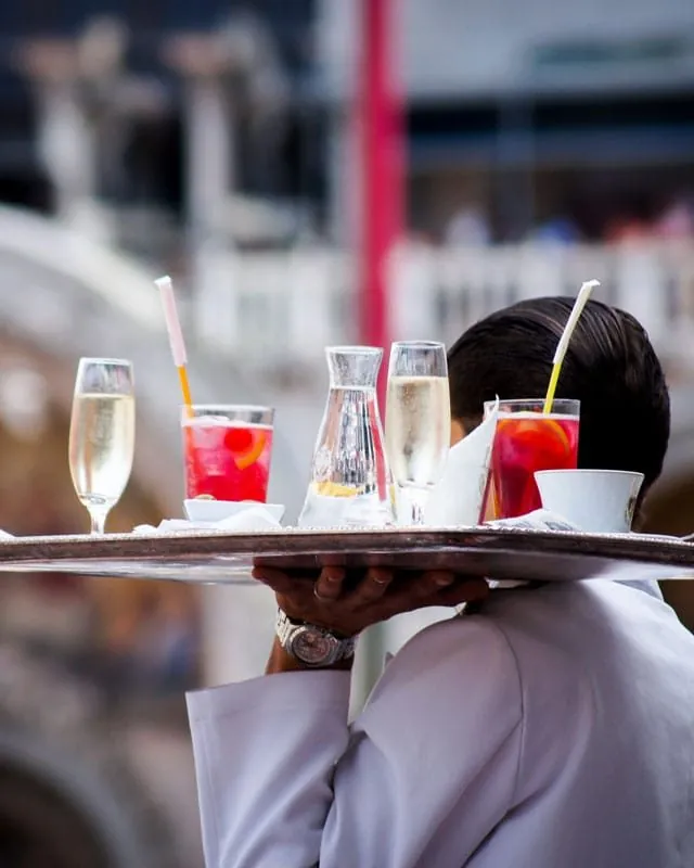 Waiter carrying a tray of drinks